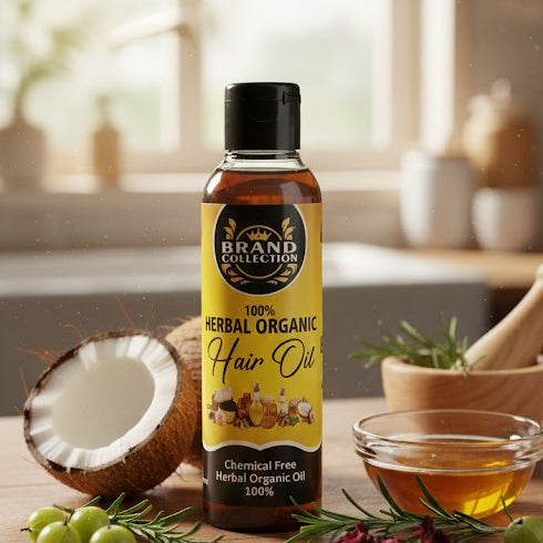 Bottle of herbal organic hair oil on a wooden table with natural ingredients.

