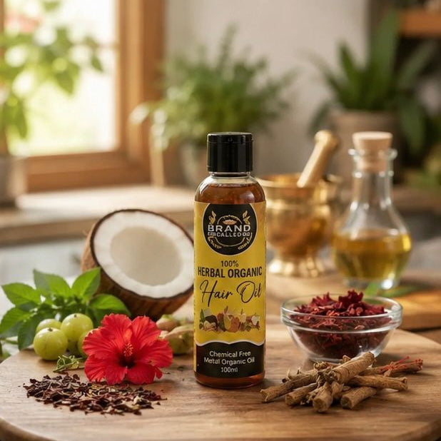 HAIR OIL BOTTLE ON WOODEN TABLE  ALONG WITH INGRDIENTS.